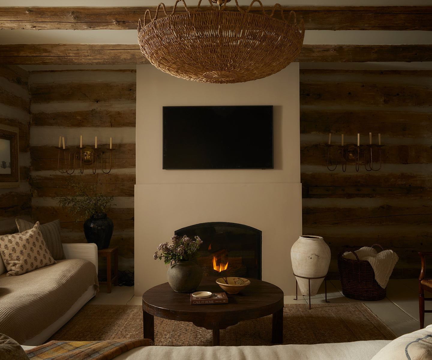 Cozy neutral living room with fireplace and sofa