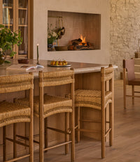 a traditional kitchen with a backed counter stool and upholstered seat. The counter stool is called Tiga. 