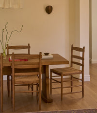 A modern dining room with oak and brown leaather dining chairs called Henrik. 