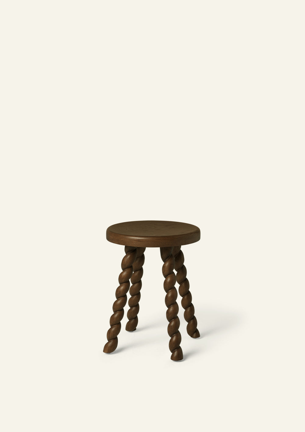 Round accent stool crafted from solid oak with a rich brown finish and four sculptural spiral-turned legs. Its compact scale and playful silhouette bring character to bedrooms, bathrooms, and living spaces.