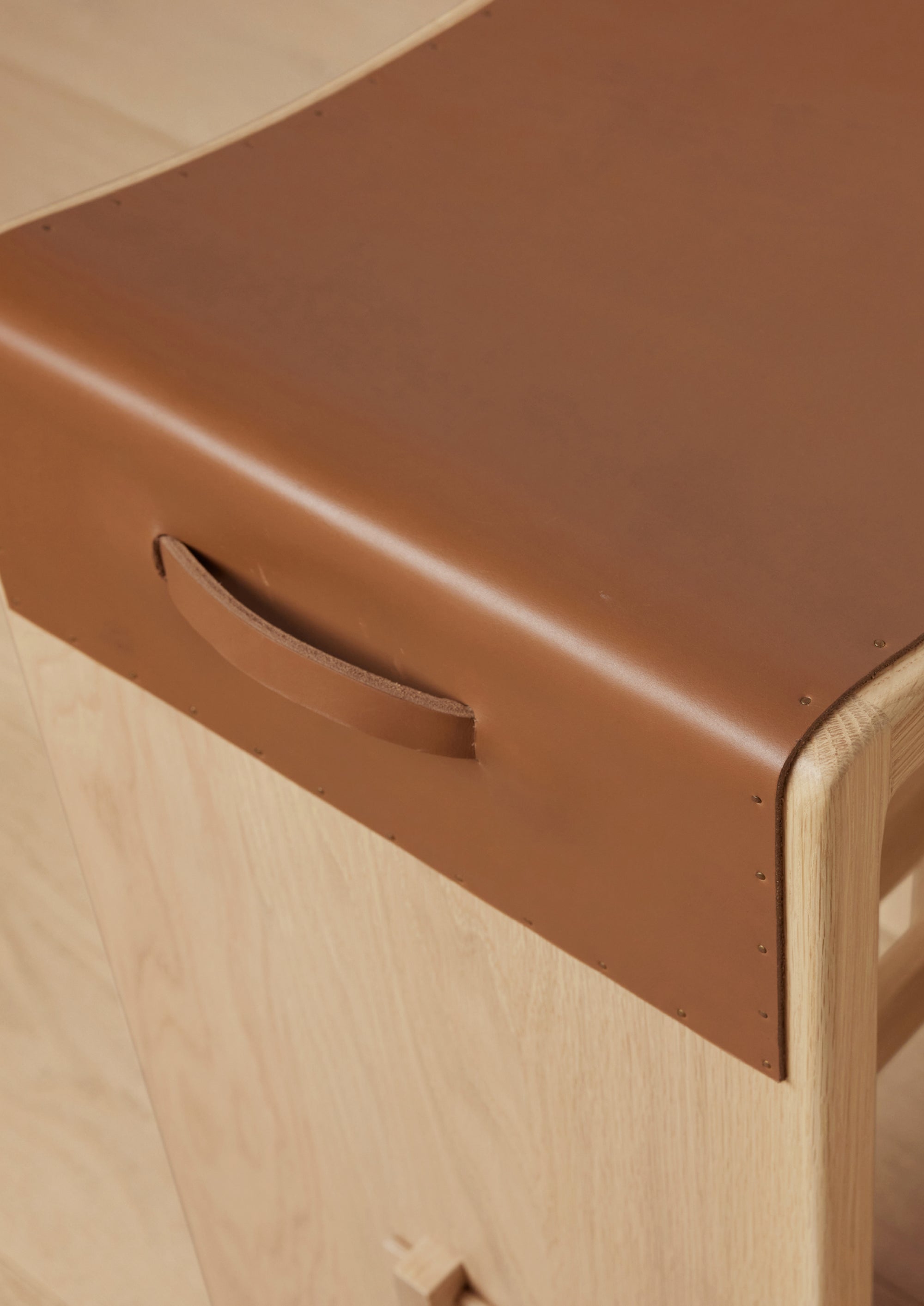 Seat detail image of the Aya counter stool's leather seat. 