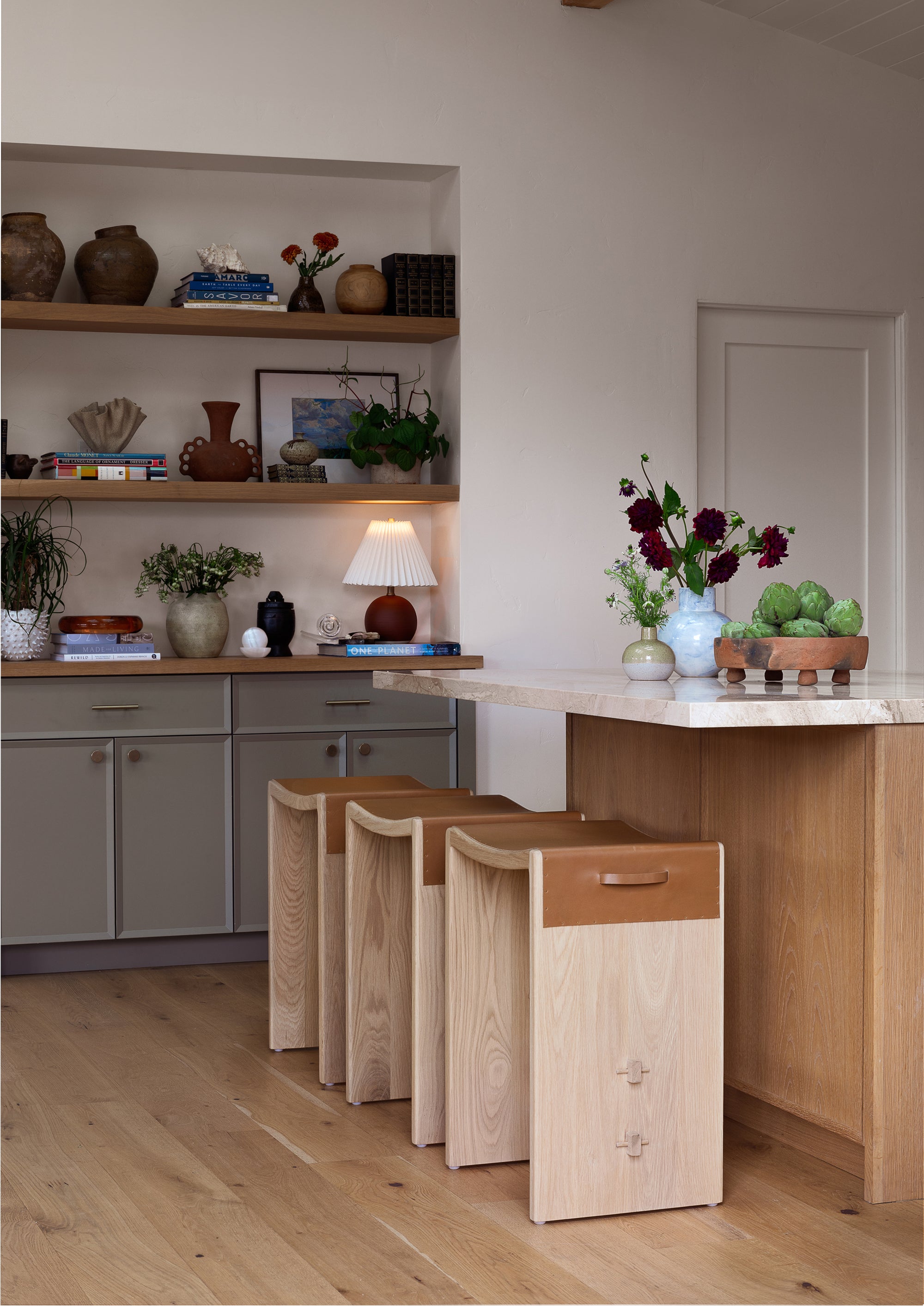 Aya backless counter stool at a kitchen counter with a neutral color scheme.