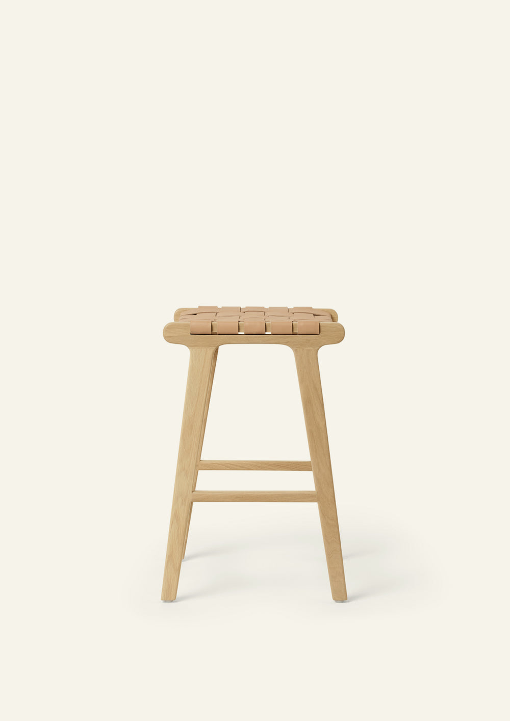 Side view of the Bali Counter Stool in solid white oak with a handwoven leather seat. The sculptural form and woven detailing create a timeless design suited for a variety of interiors.