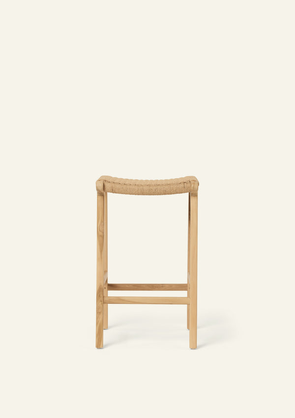 Front view of the Bali Counter Stool featuring a woven natural paper cord seat and solid teak frame. The open weave introduces texture while maintaining an airy, minimalist aesthetic.
