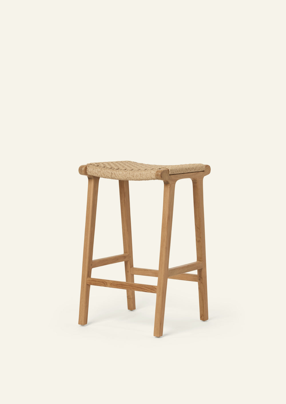 Angled view of the Bali Counter Stool in solid teak with a woven synthetic paper cord seat. The combination of natural materials and refined craftsmanship creates a timeless, versatile design.