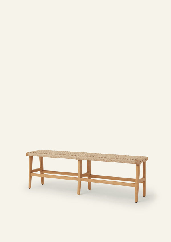 Bench crafted from teak with a woven synthetic paper cord seat. The clean-lined frame, tapered legs, and airy silhouette create a versatile piece suited for both indoor and outdoor spaces.