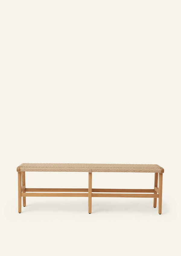 Wide view of the bench’s teak frame and woven synthetic paper cord seat. The image showcases the craftsmanship of the joinery, tapered leg profile, and durable woven surface.