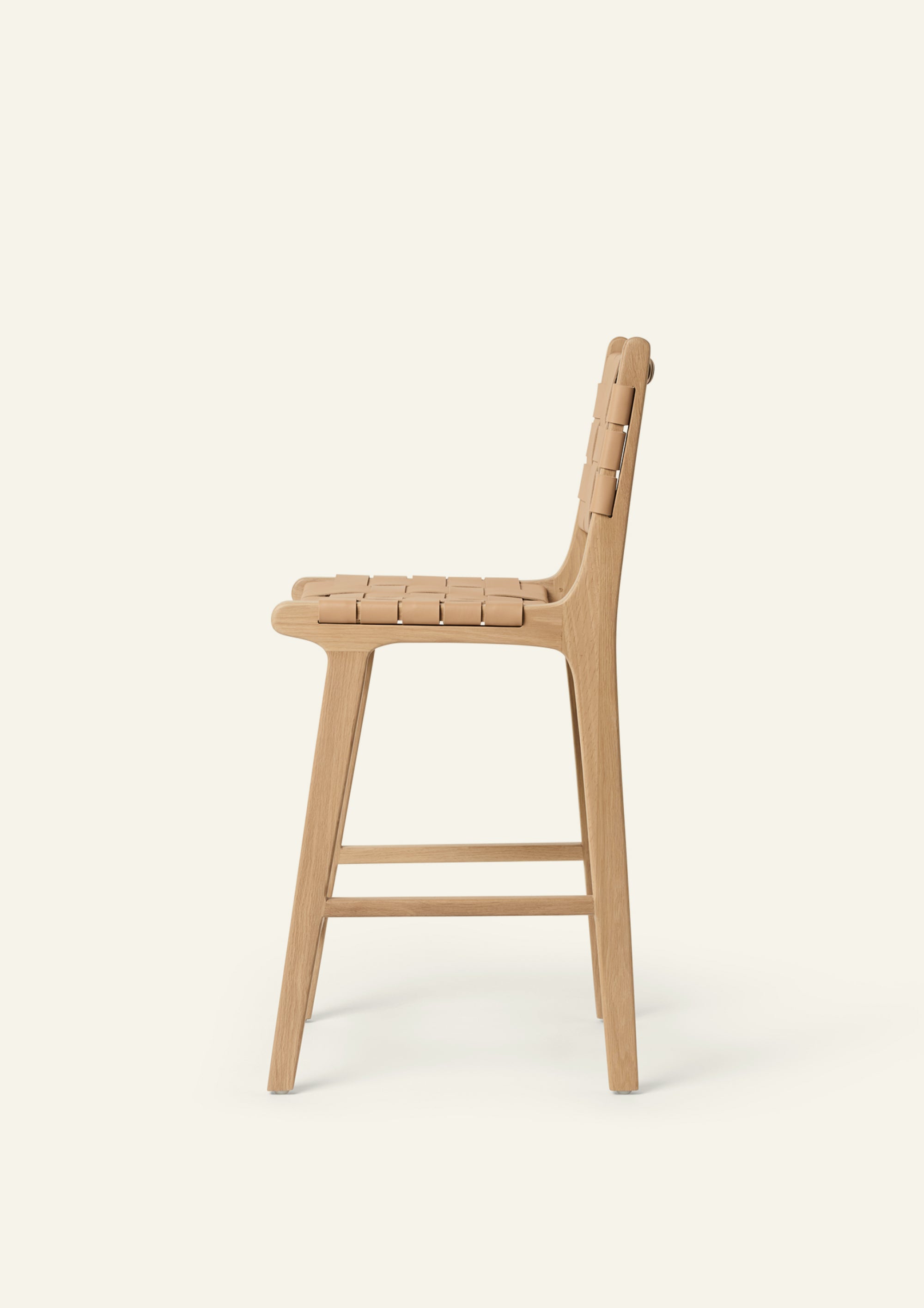 Bali Counter Stool crafted from solid white oak with a handwoven full-grain leather seat and back, shown in profile.