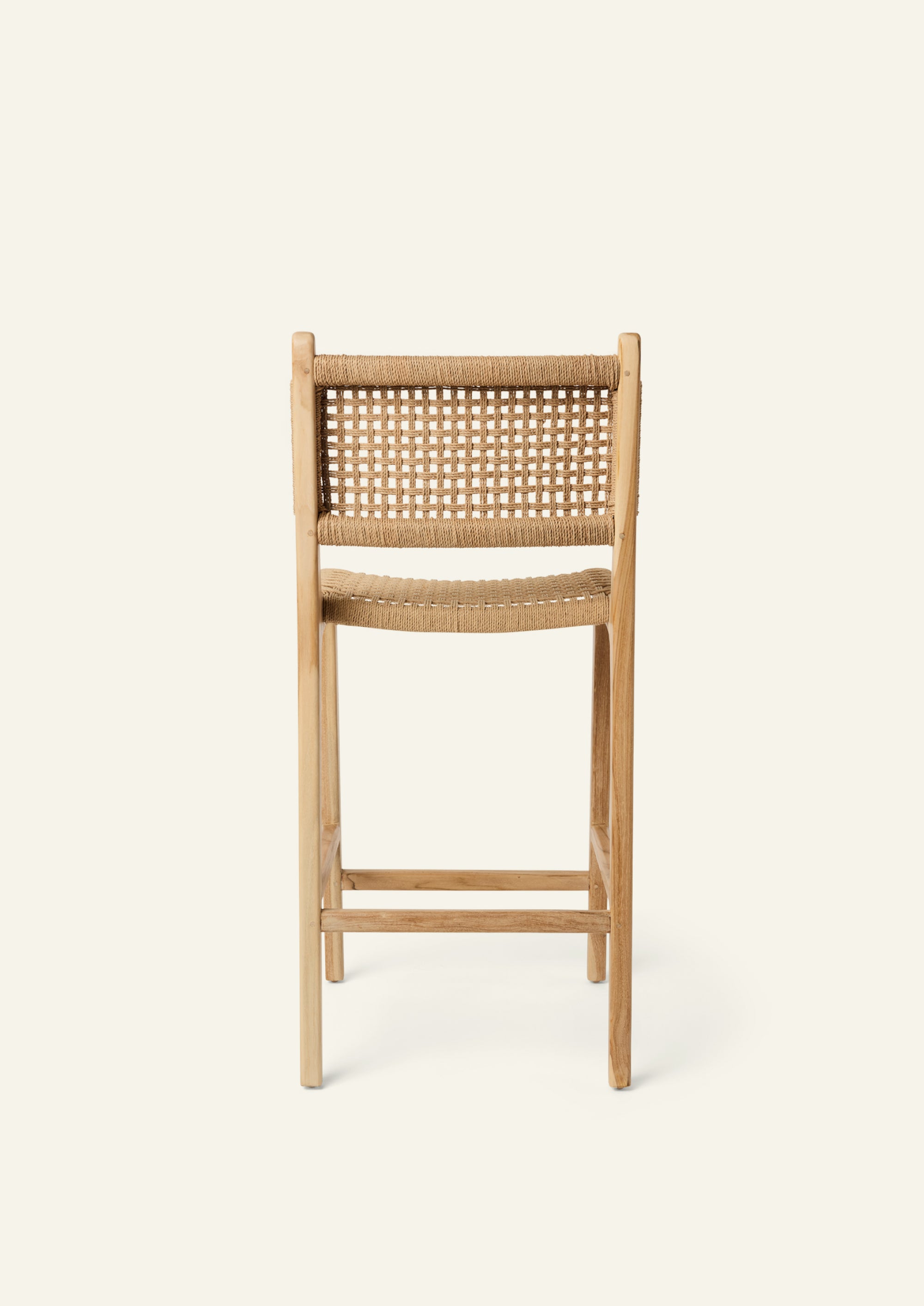 Back view of the Bali Counter Stool crafted from solid high-grade teak with a handwoven paper cord seat and back. The gently curved frame and woven texture create a relaxed silhouette suited for indoor and outdoor dining.