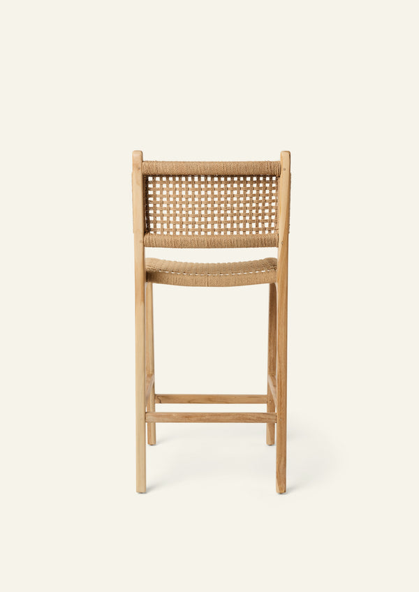 Back view of the Bali Counter Stool crafted from solid high-grade teak with a handwoven paper cord seat and back. The gently curved frame and woven texture create a relaxed silhouette suited for indoor and outdoor dining.