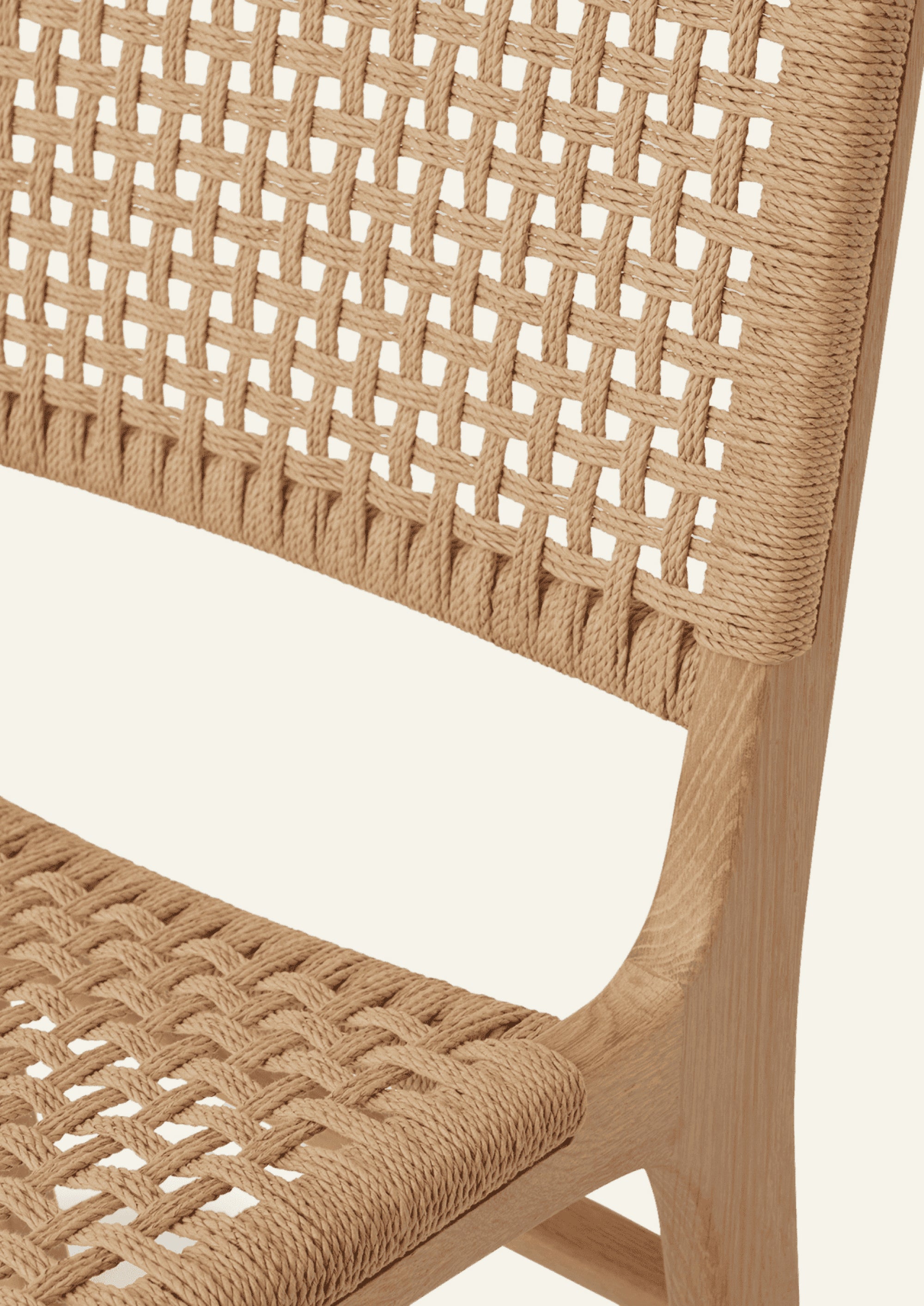 Close-up of the Bali Counter Stool highlighting the intricate paper cord weave and smooth teak joinery. The texture-rich weave adds warmth while offering enhanced durability for everyday use.