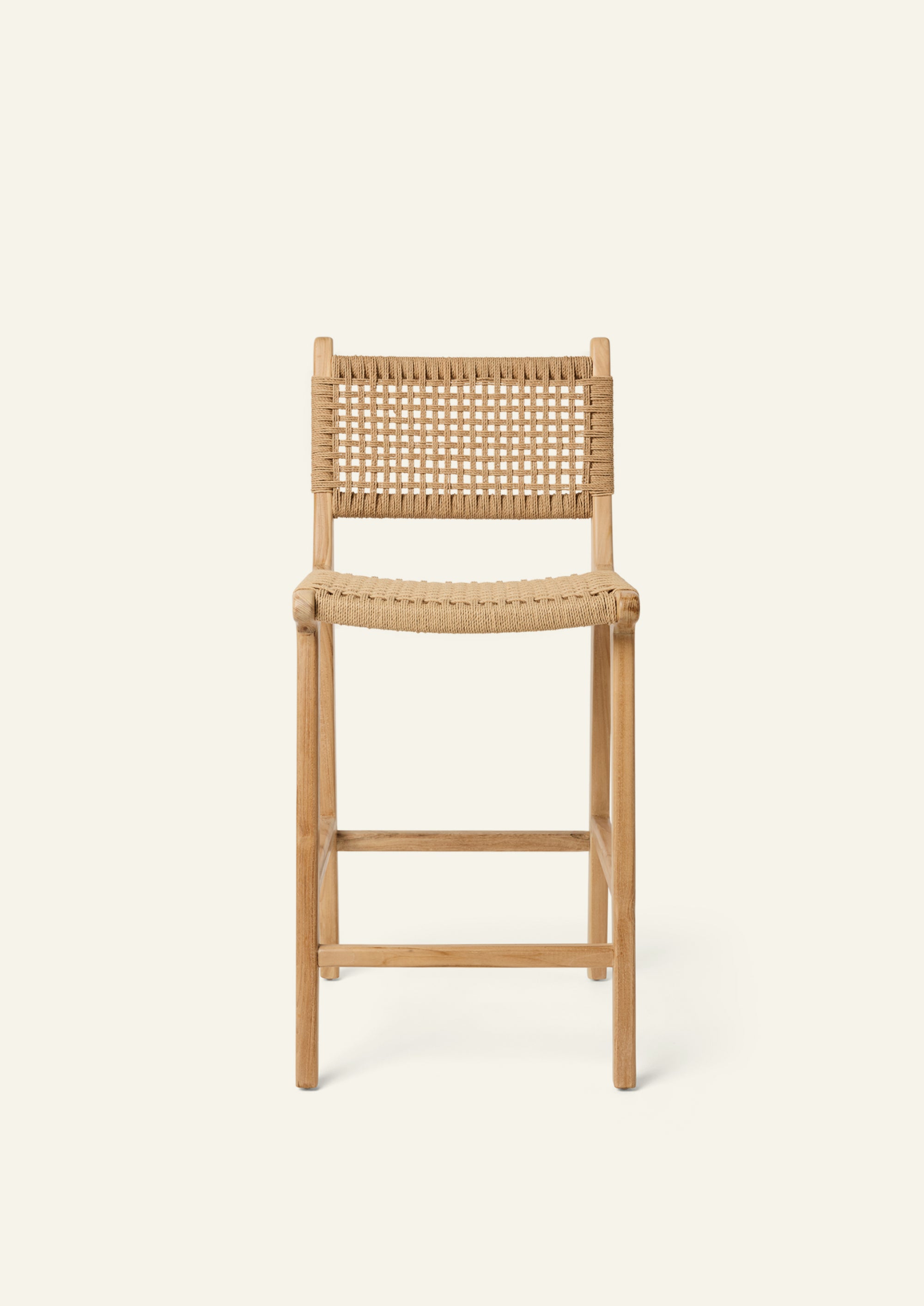 Front View of the Bali Counter Stool crafted from solid high-grade teak with a handwoven paper cord seat and back. The gently curved frame and woven texture create a relaxed silhouette suited for indoor and outdoor dining.