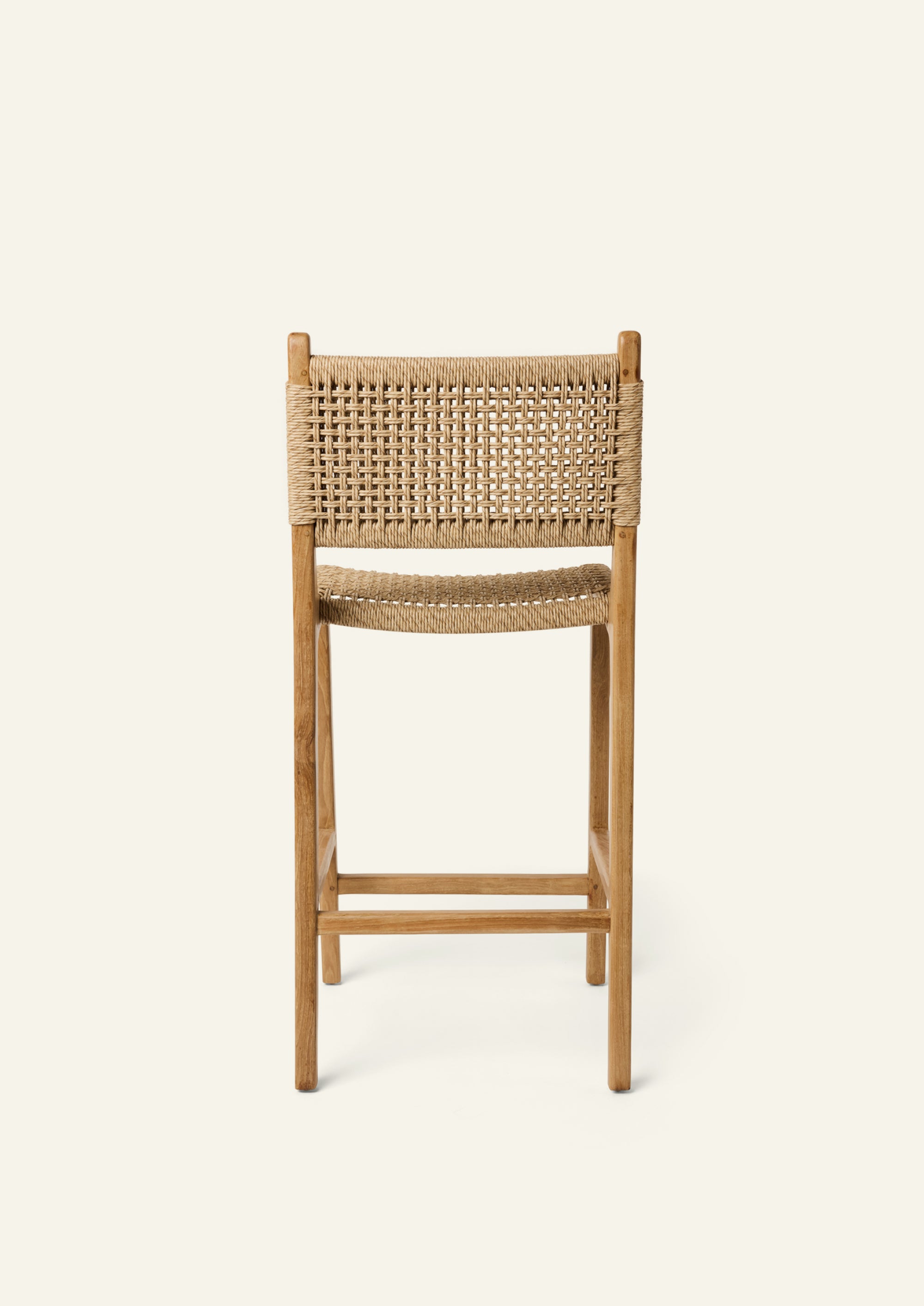 Back view of the Bali Counter Stool crafted from solid high-grade teak with a handwoven synthetic paper cord seat and back. The gently curved frame and woven texture create a relaxed silhouette suited for indoor and outdoor dining.