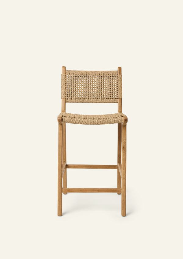 Front view of the Bali Counter Stool crafted from solid high-grade teak with a handwoven synthetic paper cord seat and back. The gently curved frame and woven texture create a relaxed silhouette suited for indoor and outdoor dining.