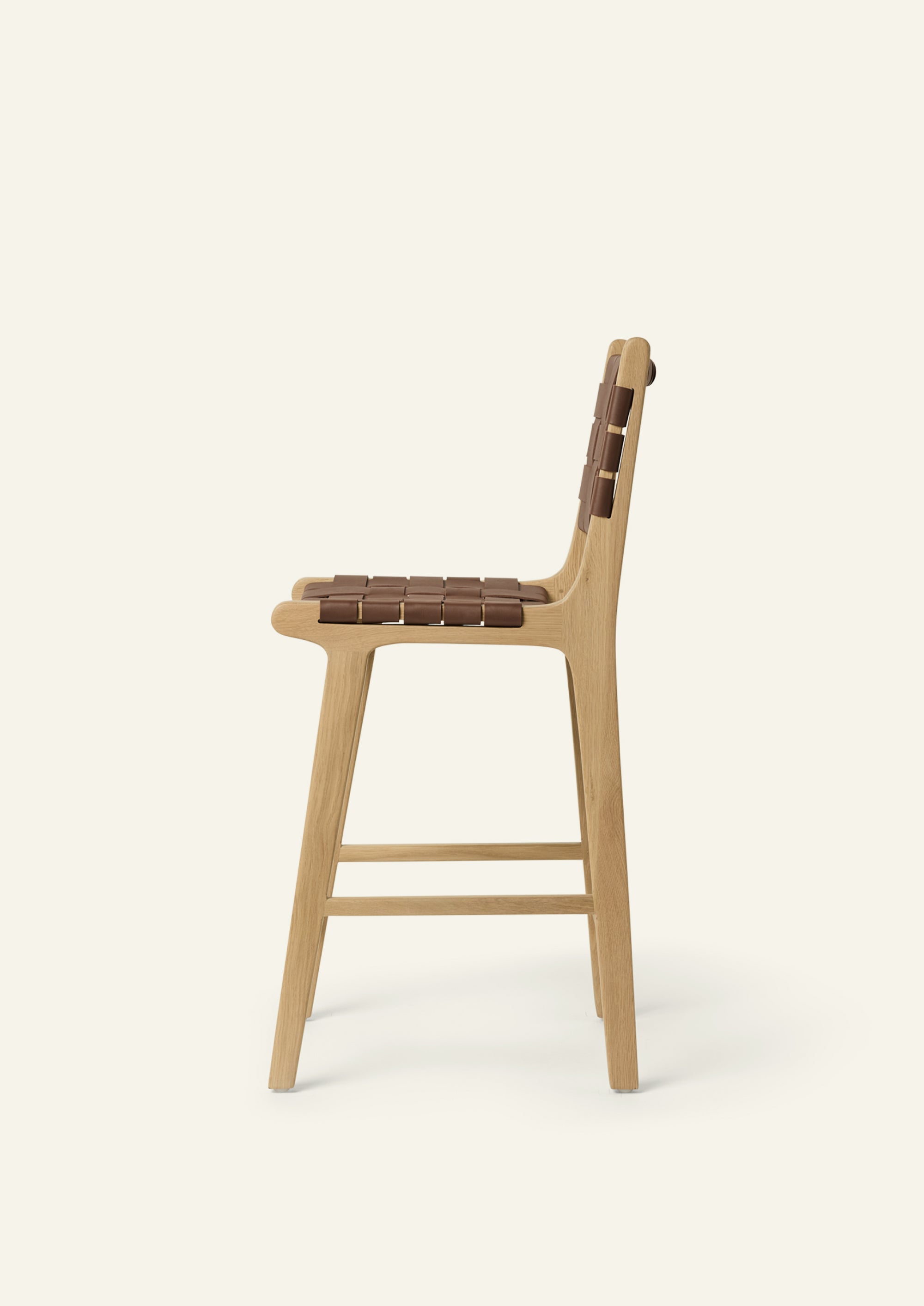 Side view of the Bali Counter Stool in solid white oak with handwoven whiskey leather.