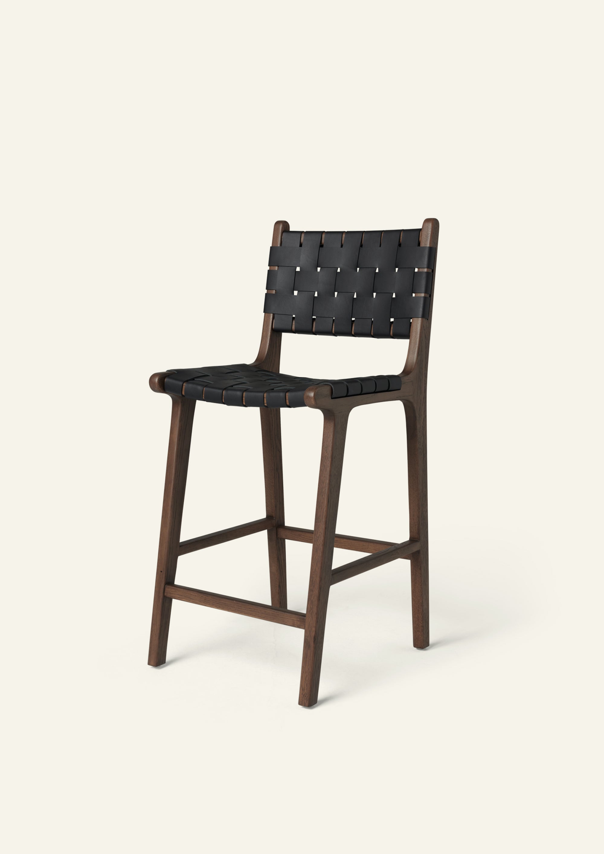 Bali Counter Stool in solid brown oak with handwoven black leather, shown in a three-quarter view.