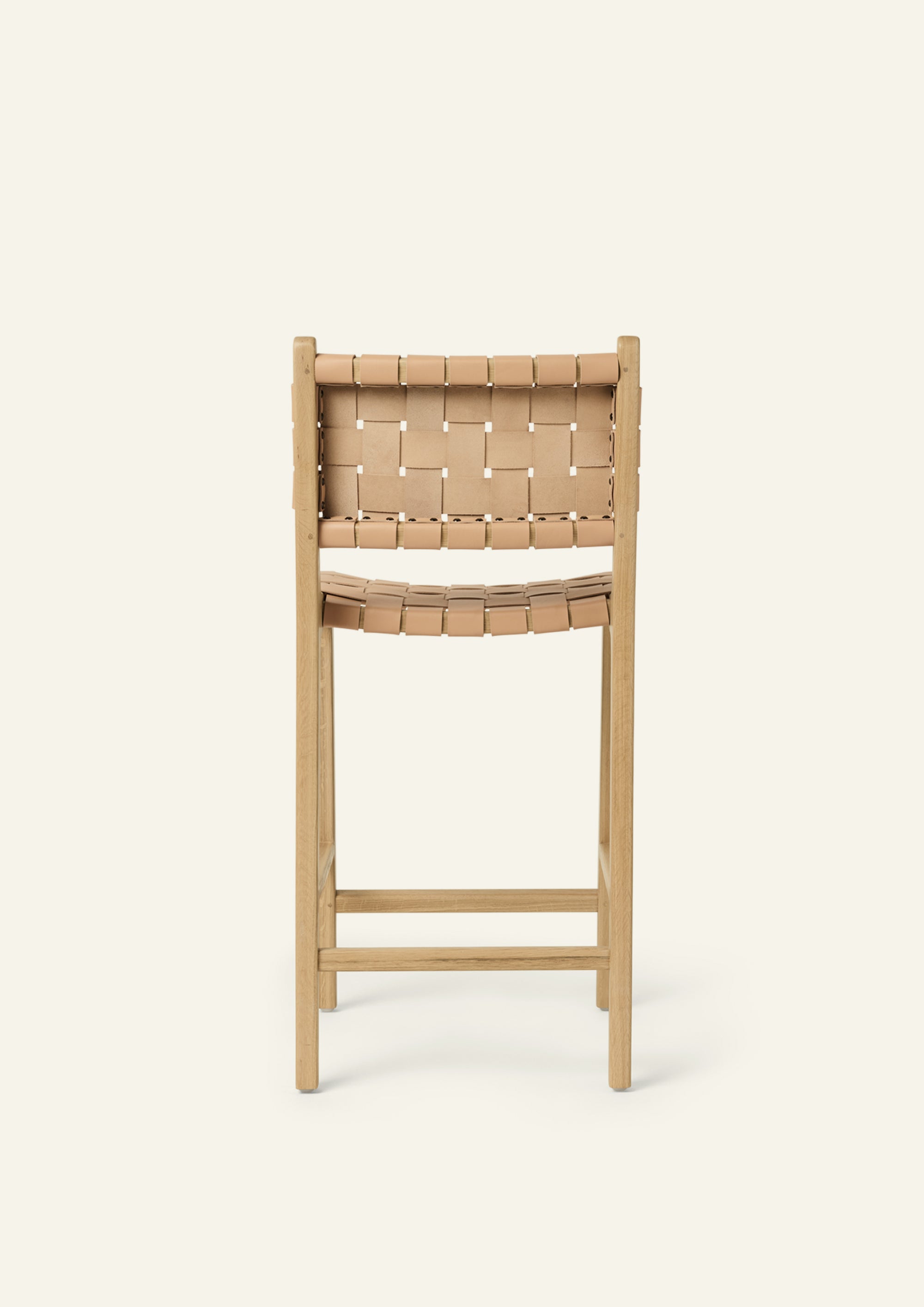 Rear view of the Bali Counter Stool highlighting the handwoven full-grain natural leather backrest and white oak construction.