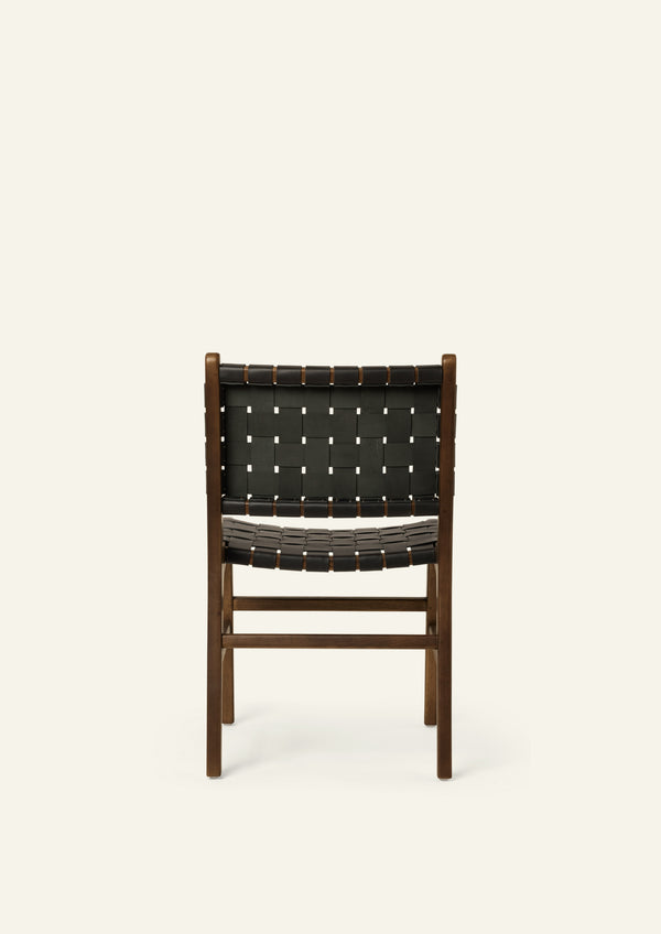 Rear view of the Bali Dining Chair showcasing the handwoven black leather back panel and solid brown oak construction. The woven pattern highlights the chair’s craftsmanship and architectural form.