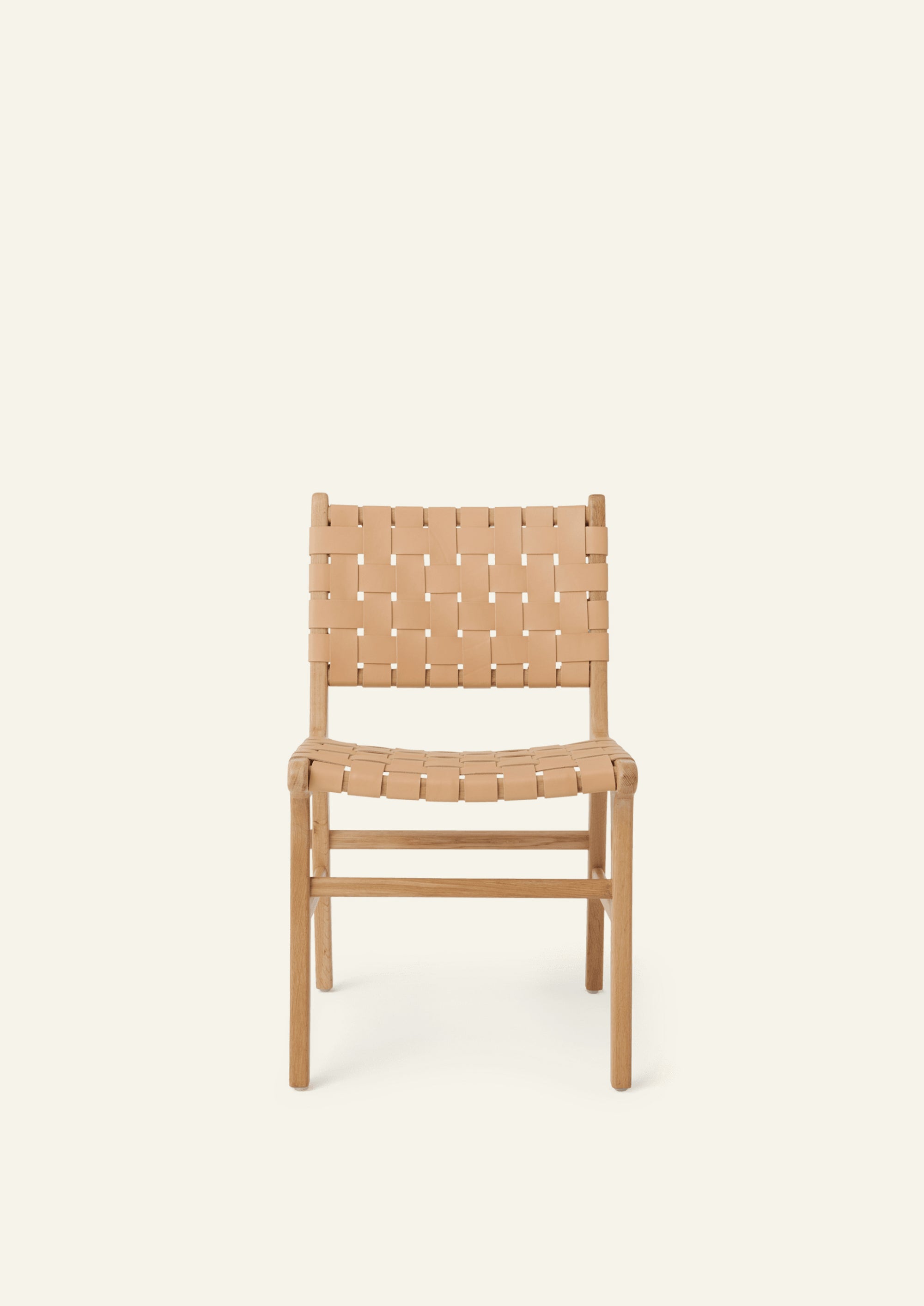 Front view of the Bali Dining Chair in white oak with woven full-grain natural leather. Rounded edges, tapered legs, and warm natural materials create a refined yet approachable dining chair.
