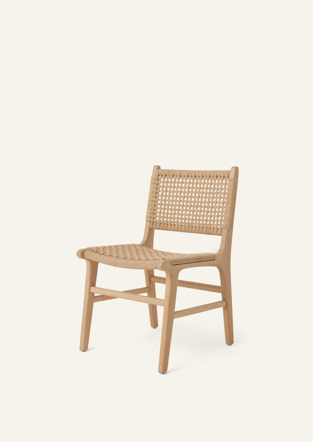 Bali Dining Chair crafted from solid white oak with a handwoven paper cord seat and back, shown in a three-quarter view.