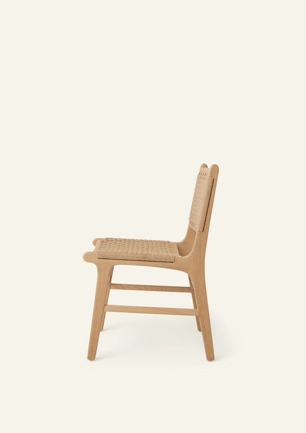 Side view of the Bali Dining Chair crafted from solid white oak with a handwoven paper cord seat and back.