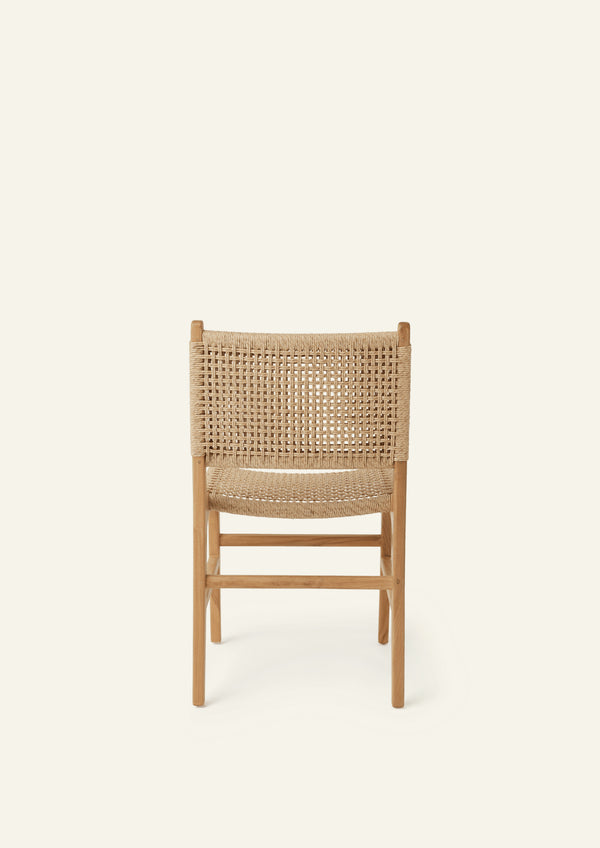 Back view of the Bali Dining Chair with a woven synthetic paper cord seat and back paired with a solid teak frame. The natural materials and clean lines create a timeless outdoor-inspired aesthetic.