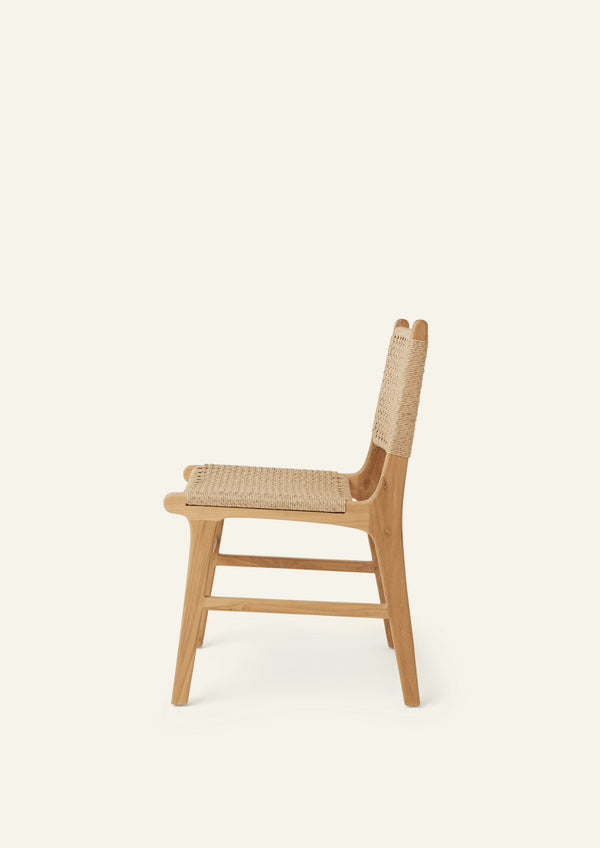 Side view of the Bali Dining Chair with a woven synthetic paper cord seat and back paired with a solid teak frame. The natural materials and clean lines create a timeless outdoor-inspired aesthetic.
