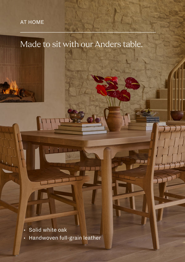 Made to sit with the Anders Dining Table in white oak. The Anders Dining Chair styled around a solid wood dining table in a warm, inviting interior. The woven leather construction complements natural materials and creates a relaxed, elevated dining setting.