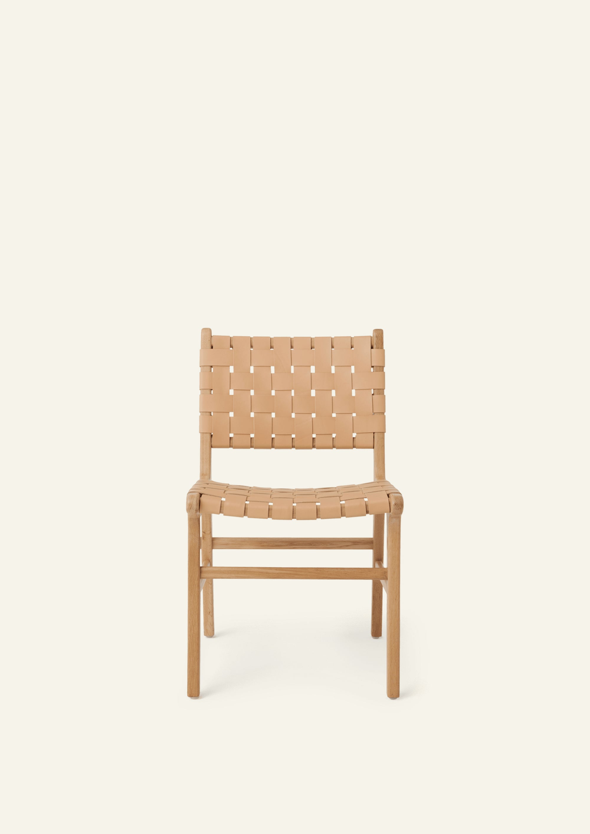 Front view of the Bali Dining Chair featuring woven full-grain leather straps across the seat and back. The open weave introduces texture and visual lightness while maintaining a clean, architectural profile.