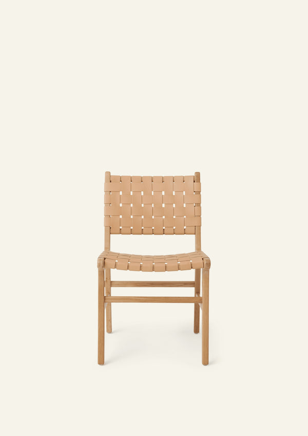 Front view of the Bali Dining Chair featuring woven full-grain leather straps across the seat and back. The open weave introduces texture and visual lightness while maintaining a clean, architectural profile.