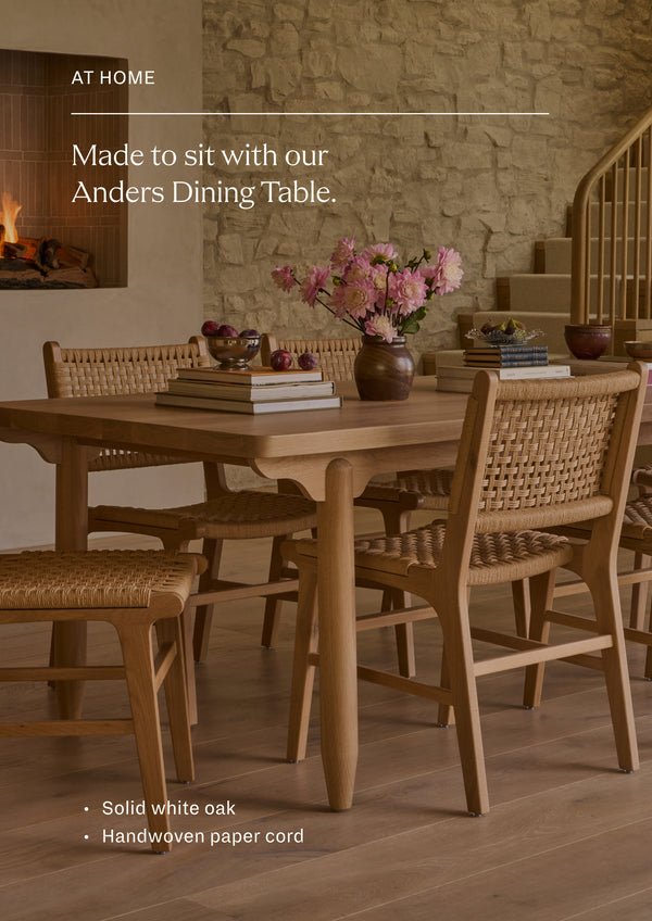 Made to sit with our Anders Dining Table. Bali Dining Chairs in handwoven paper cord gathered around the white oak Anders Dining Table in a warm, inviting dining room.