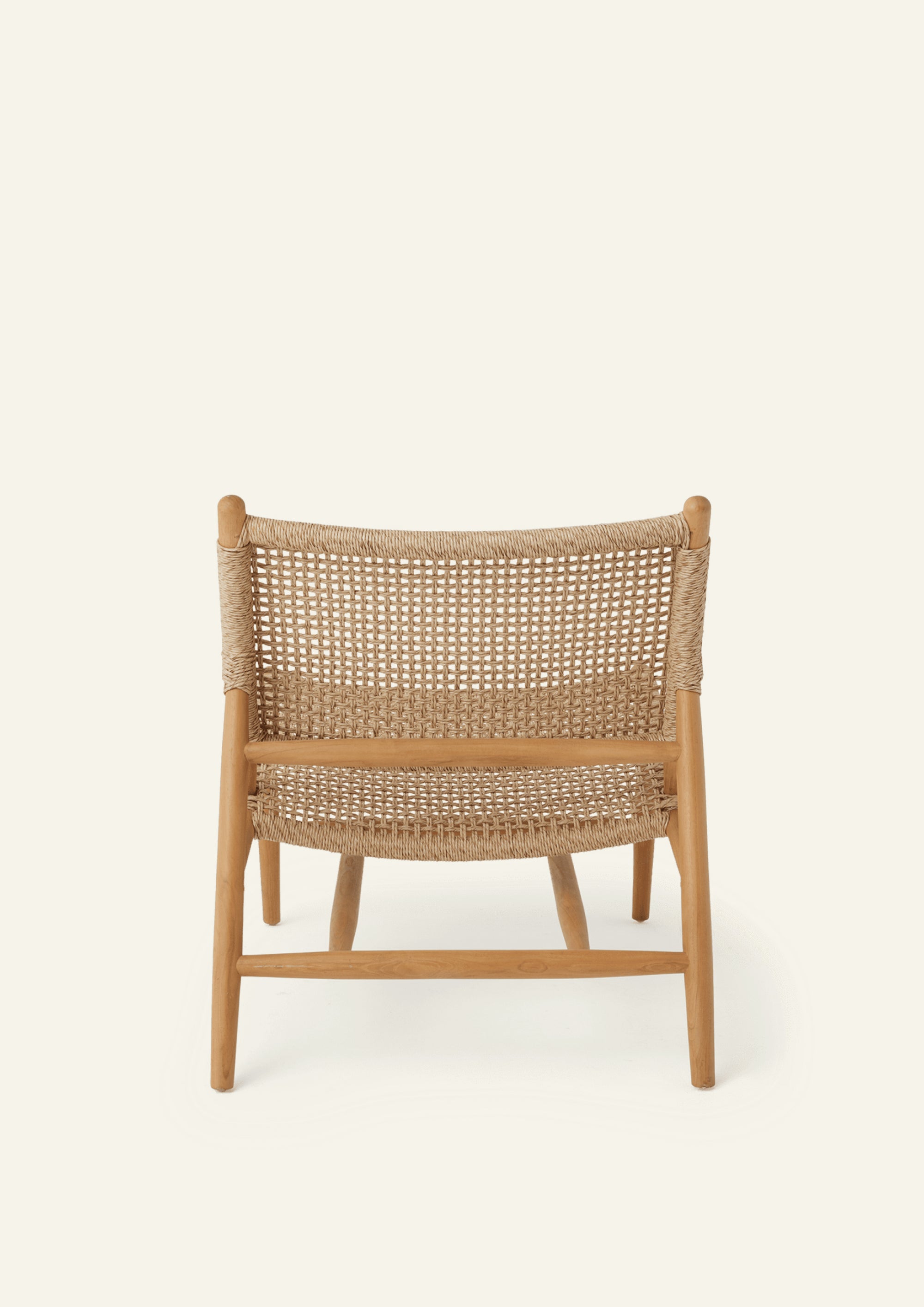 Rear view of the lounge chair featuring a woven backrest suspended within a solid teak frame. The clean geometry and woven texture create a balance of support, comfort, and visual lightness.