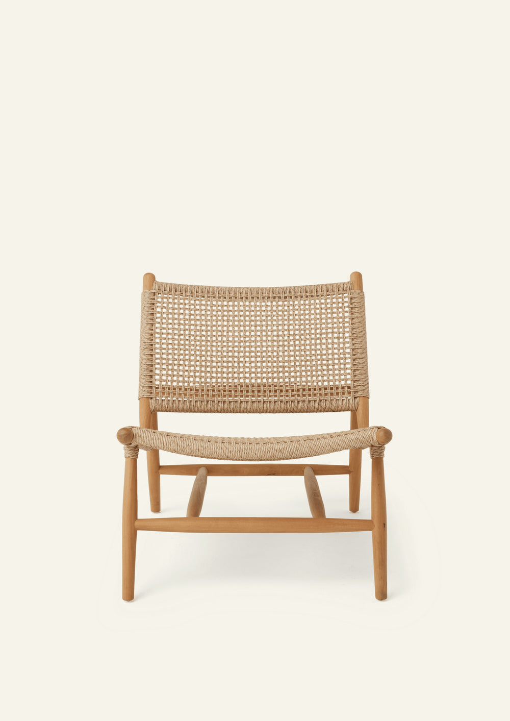 Front view of the lounge chair featuring a woven synthetic paper cord seat and backrest supported by a solid teak frame. The generous proportions and gently reclined profile offer casual comfort and timeless style.