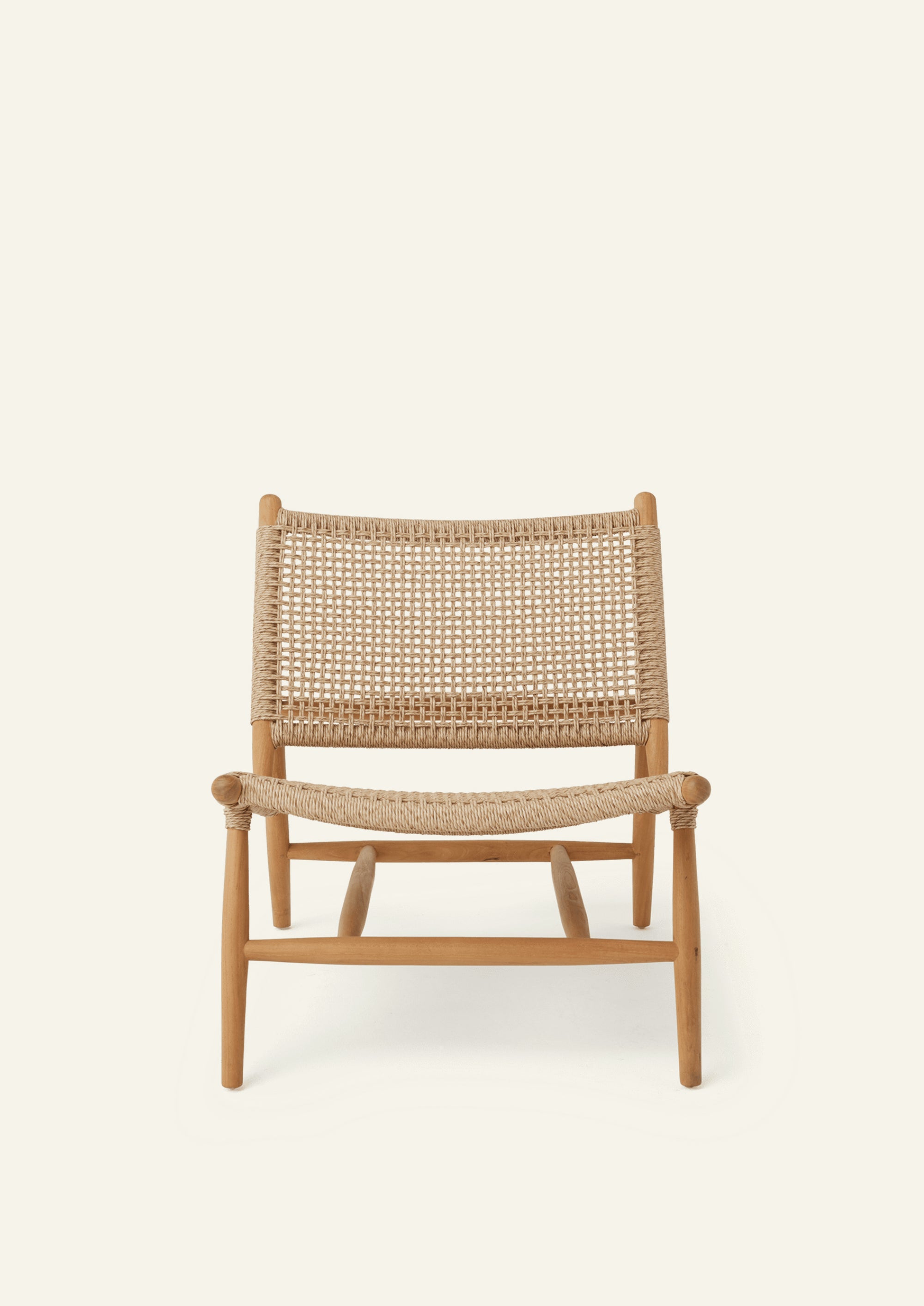 Front view of the lounge chair featuring a woven synthetic paper cord seat and backrest supported by a solid teak frame. The generous proportions and gently reclined profile offer casual comfort and timeless style.