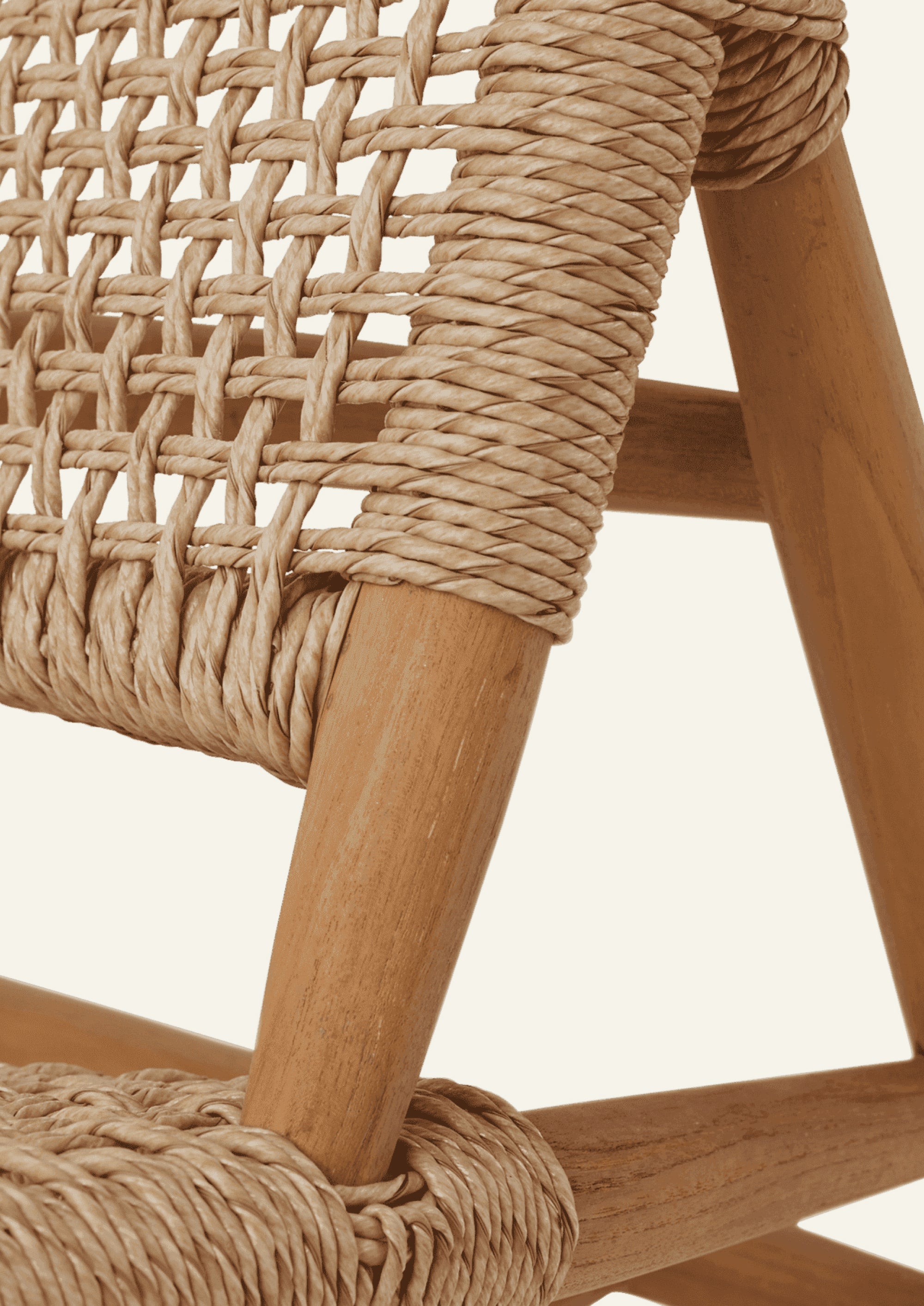 Close-up of the woven backrest showing the intricate open-weave pattern and synthetic paper cord wrapped around the teak frame. The handcrafted detailing highlights the chair’s texture, durability, and craftsmanship.