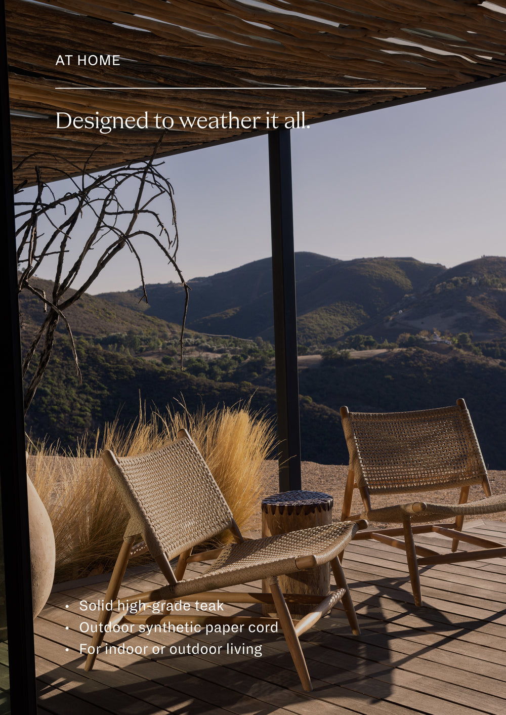 Pair of woven teak lounge chairs arranged outdoors around a small side table in a desert-inspired landscape. The collection creates a relaxed retreat for conversation, reading, or enjoying the outdoors.