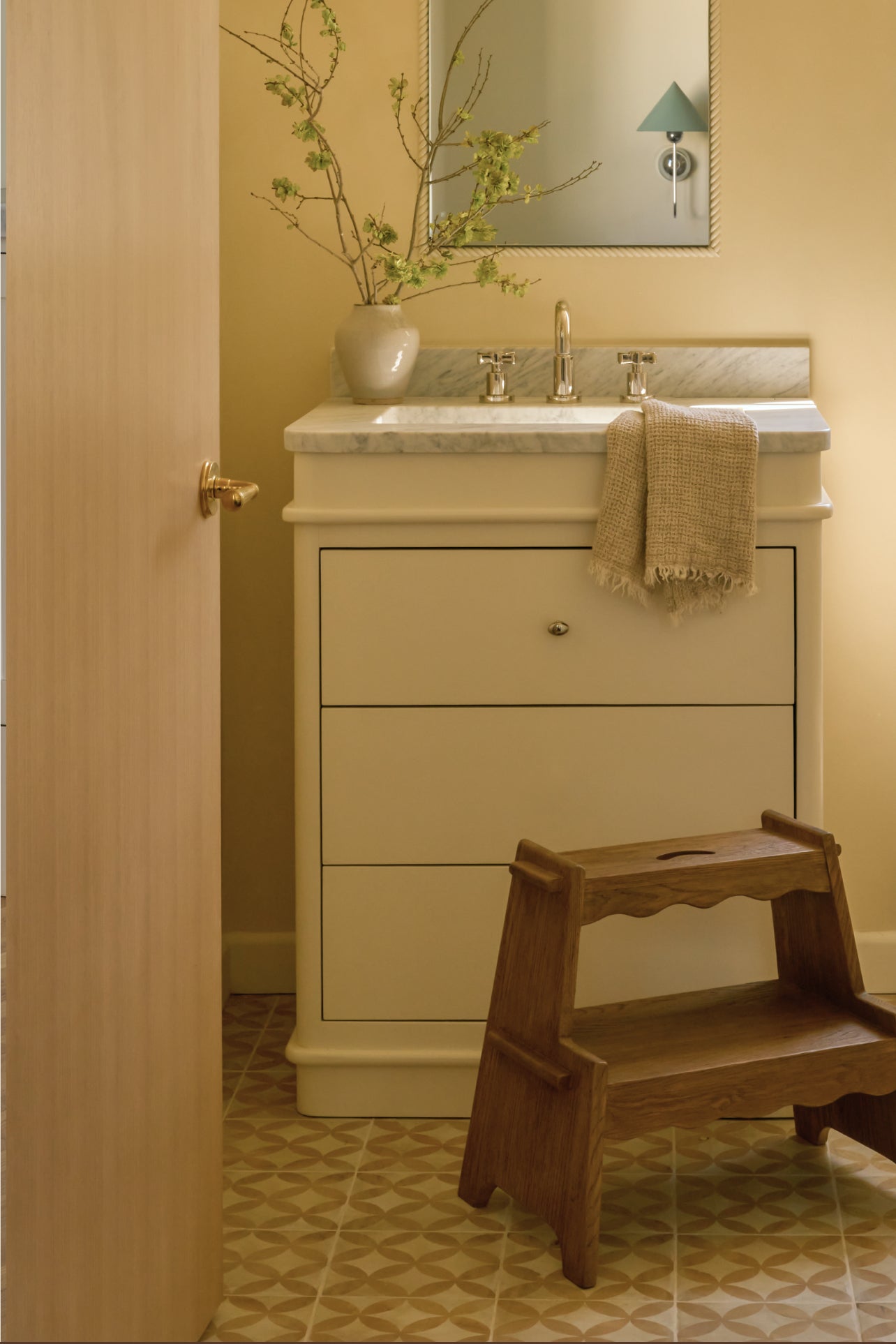 Bathroom with vanity, step stool, and decorative elements