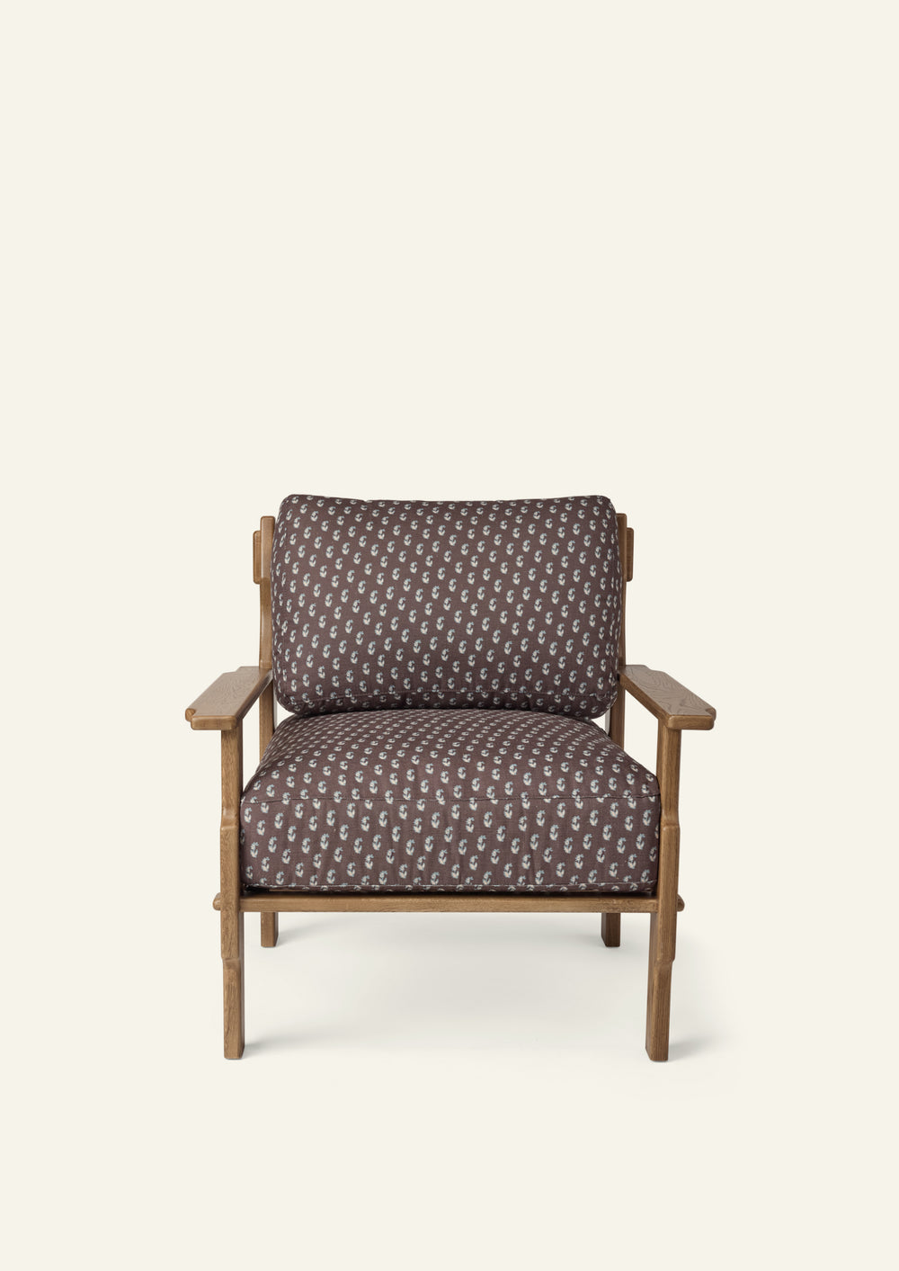 Front view of a lounge chair upholstered in Cocoa Floral fabric. Generously cushioned seat and back offer comfort, while the oak frame adds warmth and timeless character.