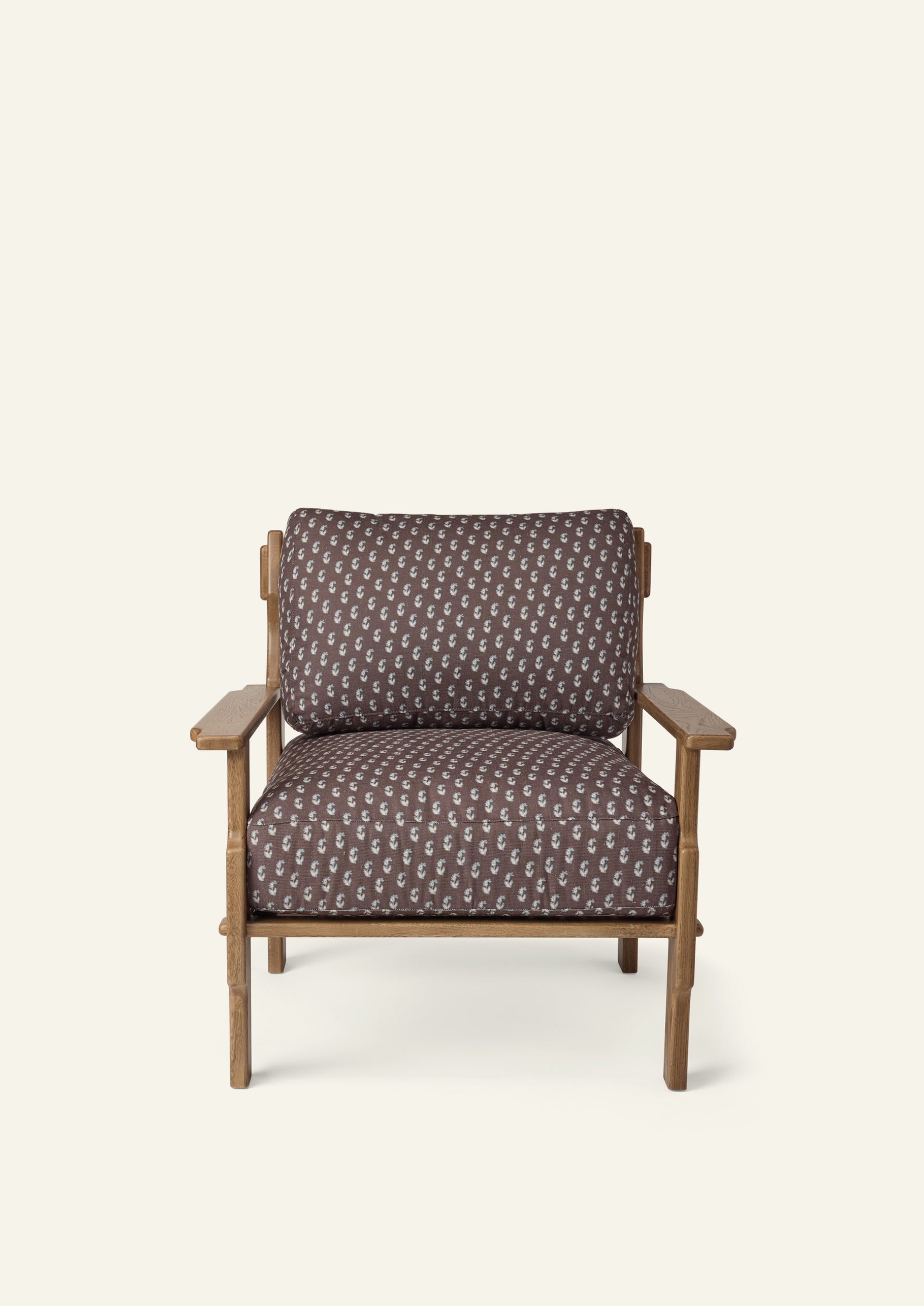 Front view of a lounge chair upholstered in Cocoa Floral fabric. Generously cushioned seat and back offer comfort, while the oak frame adds warmth and timeless character.