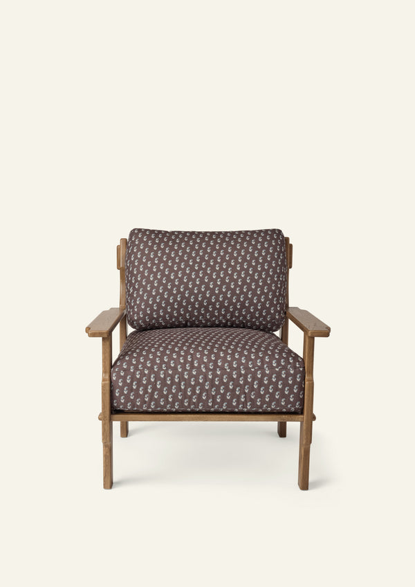 Front view of a lounge chair upholstered in Cocoa Floral fabric. Generously cushioned seat and back offer comfort, while the oak frame adds warmth and timeless character.
