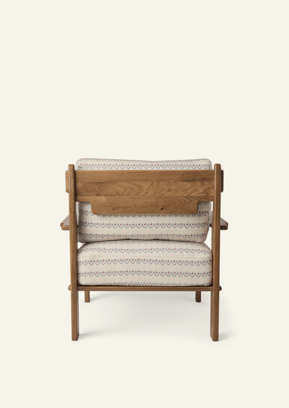 Rear view of the lounge chair showcasing the solid honey oak frame, exposed wood back panel, and Neutral Arches upholstered cushions. Thoughtful craftsmanship highlights the chair from every angle.