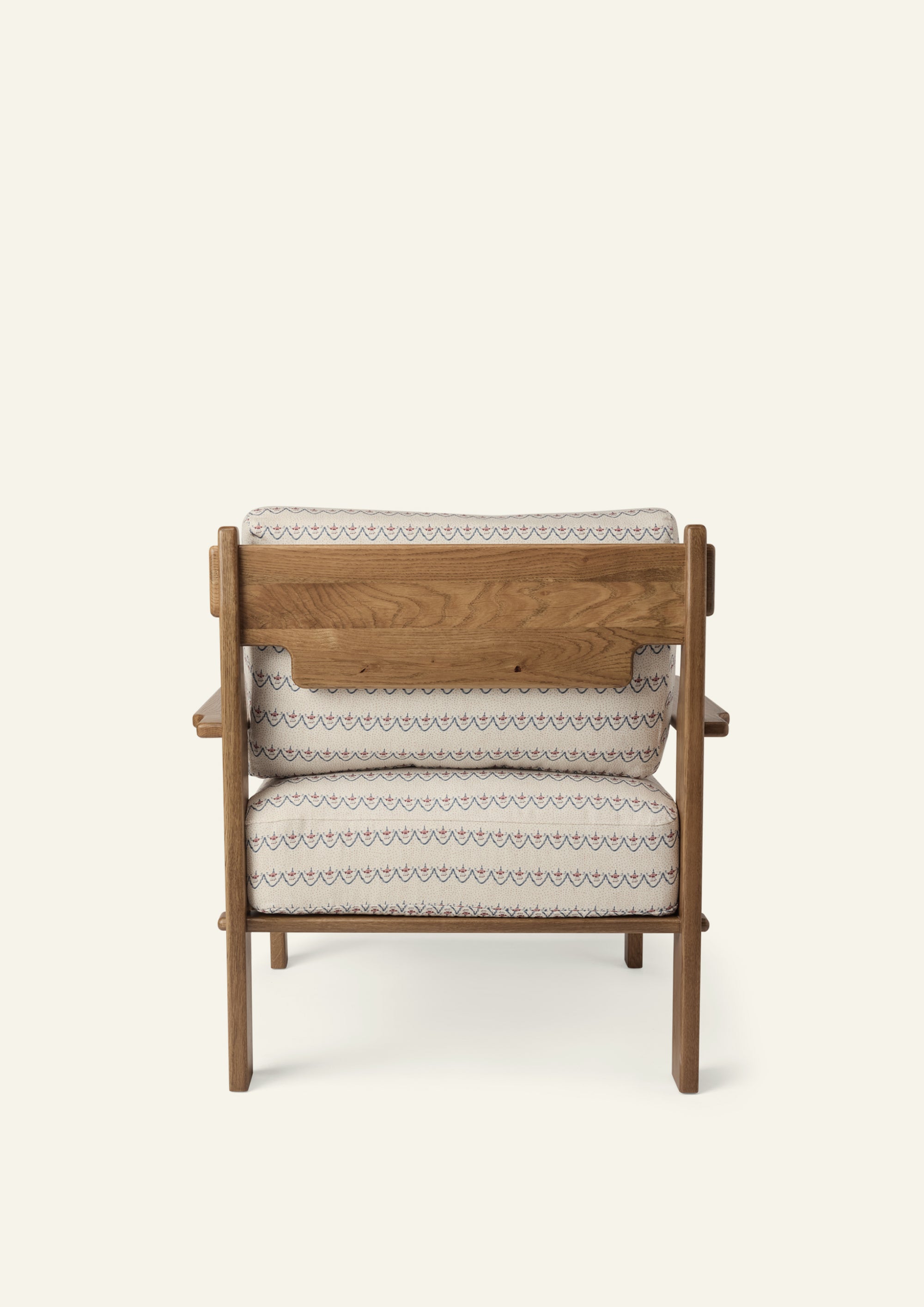 Rear view of the lounge chair showcasing the solid honey oak frame, exposed wood back panel, and Neutral Arches upholstered cushions. Thoughtful craftsmanship highlights the chair from every angle.