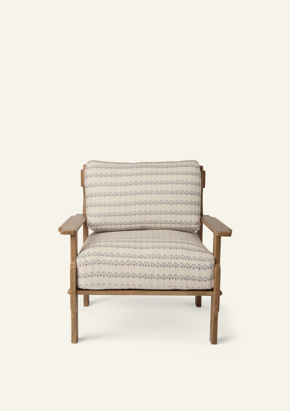 Front view of a lounge chair upholstered in Neutral Arches fabric. Generously cushioned seat and back provide comfort, while the solid oak frame adds warmth and structure.