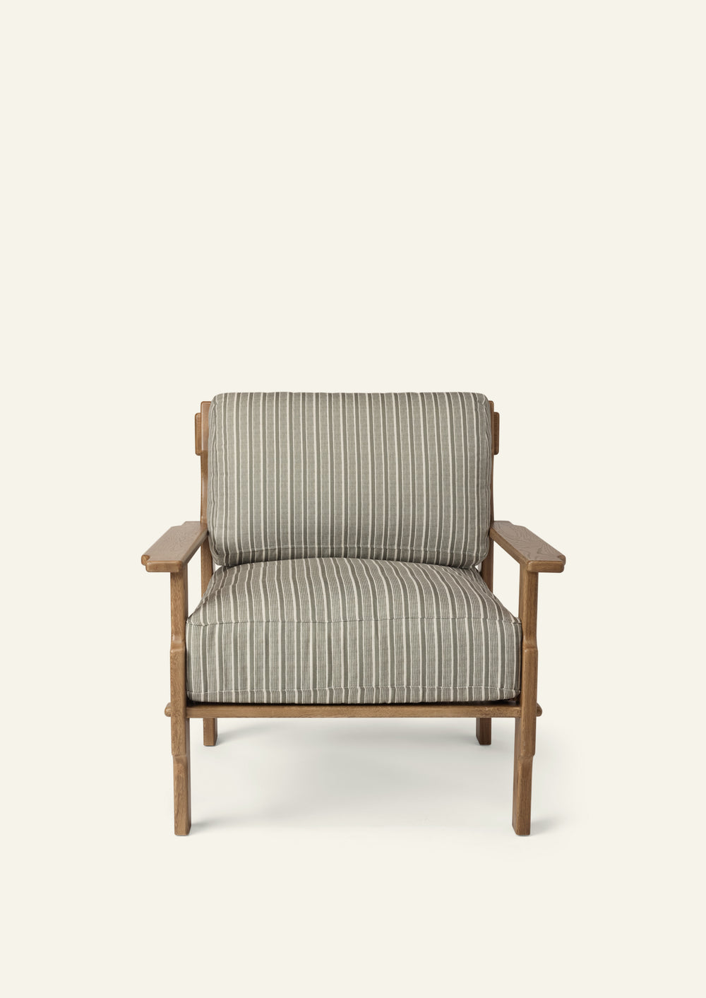 Front view of a lounge chair upholstered in Neutral Stripe fabric. Generously cushioned seat and back provide comfort, while the solid oak frame adds warmth and structure.