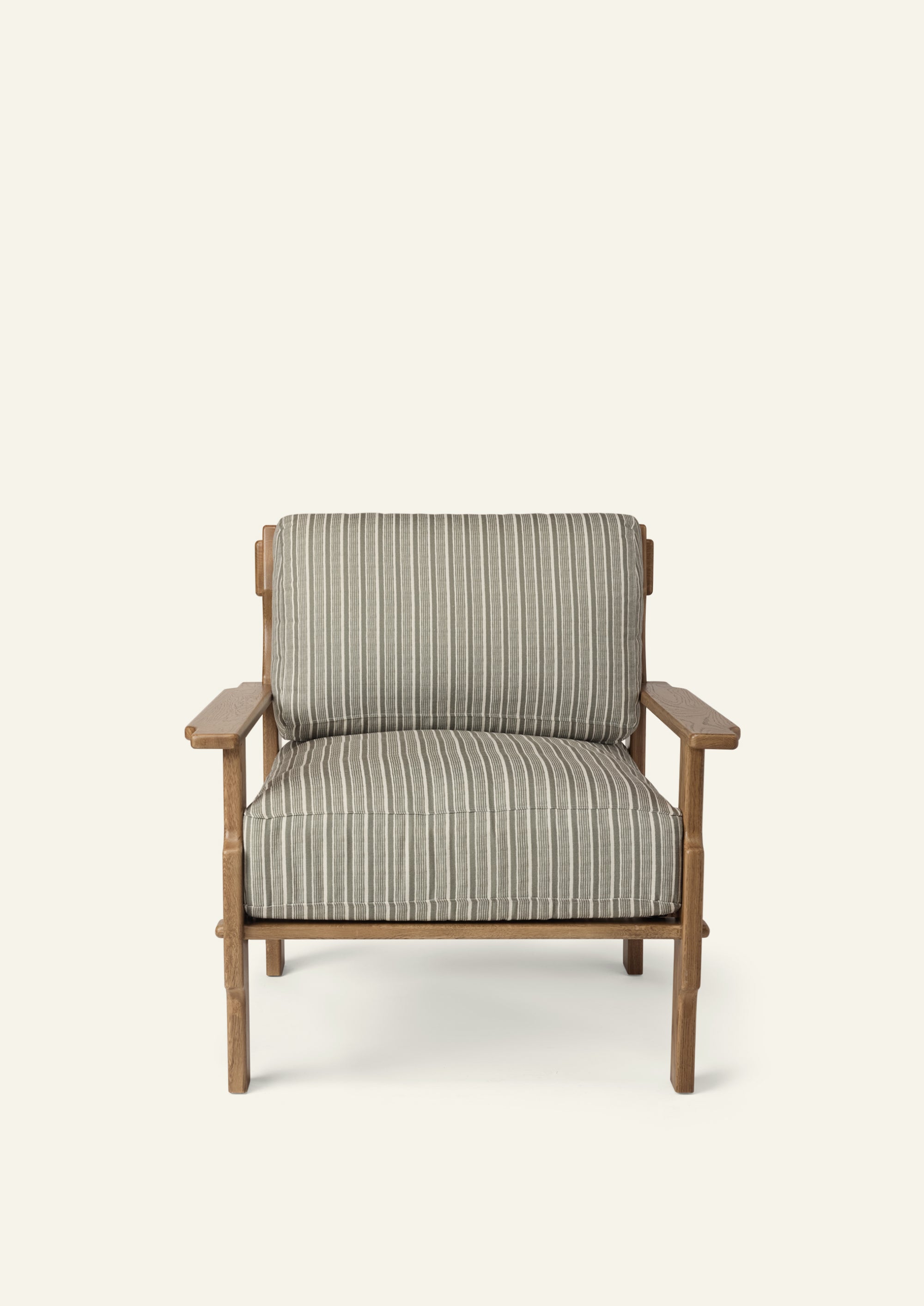 Front view of a lounge chair upholstered in Neutral Stripe fabric. Generously cushioned seat and back provide comfort, while the solid oak frame adds warmth and structure.