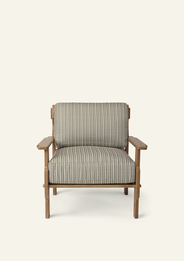 Front view of a lounge chair upholstered in Neutral Stripe fabric. Generously cushioned seat and back provide comfort, while the solid oak frame adds warmth and structure.