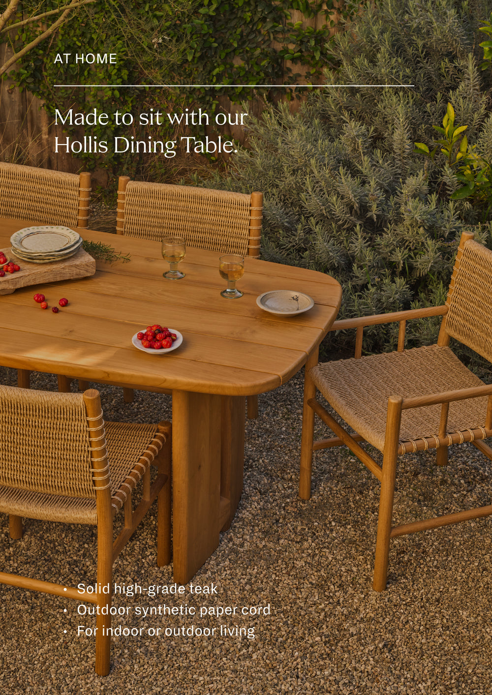 Made to sit with the Hollis Dining Table in Classic Teak. Outdoor dining armchairs arranged around a reclaimed teak dining table in a lush garden setting. Natural materials and warm tones create an inviting atmosphere for gathering and entertaining.
