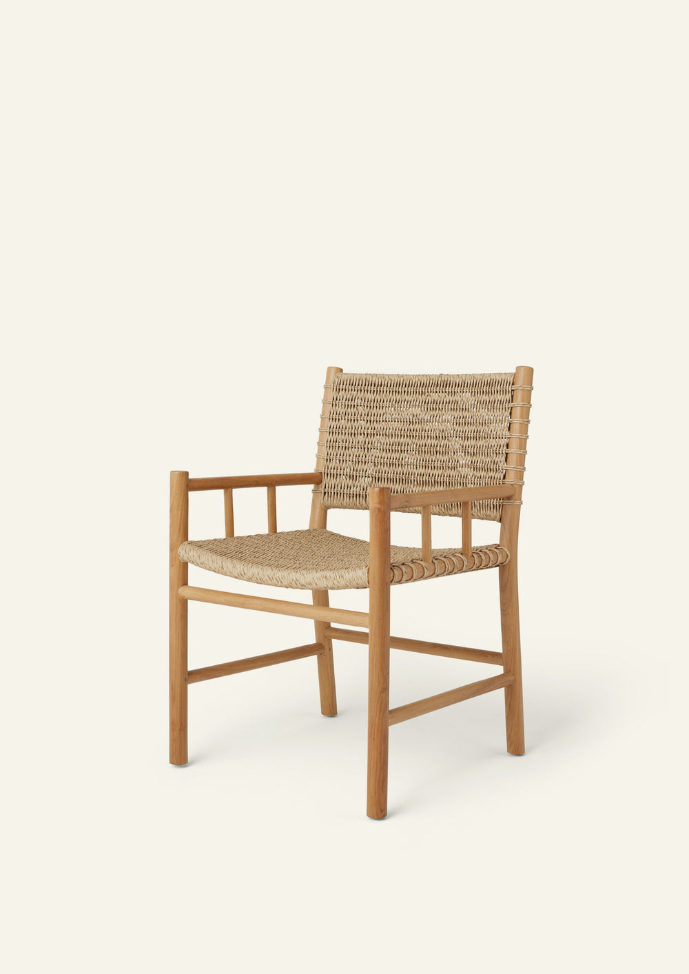 Side profile of an outdoor dining armchair crafted from solid high-grade teak and woven synthetic paper cord. Integrated armrests and a gently reclined back create a comfortable silhouette suited for indoor and outdoor living.