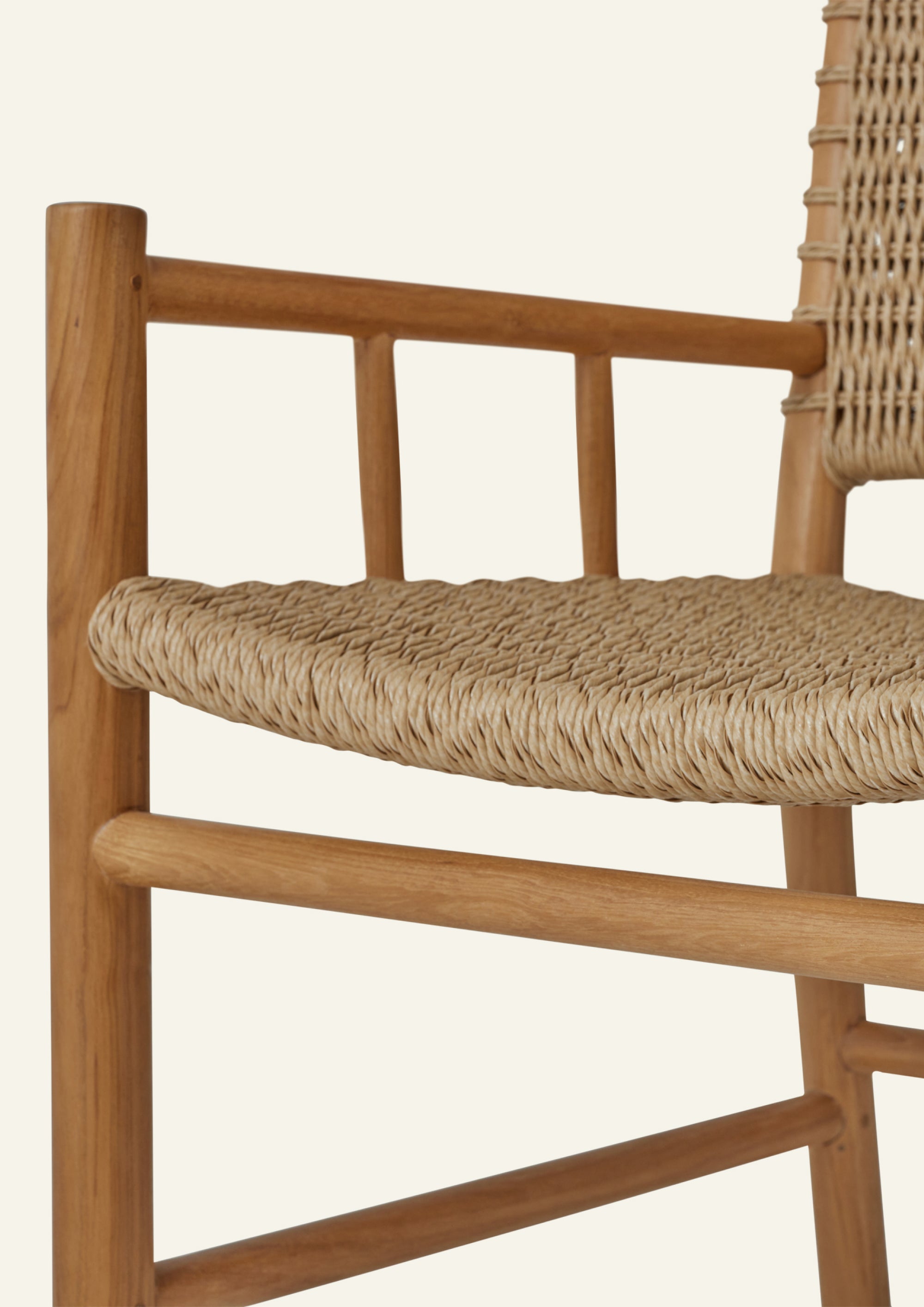Close-up of the woven seat and arm detail, highlighting the textured synthetic paper cord wrapped around a solid teak frame. The craftsmanship emphasizes durability, comfort, and natural character.