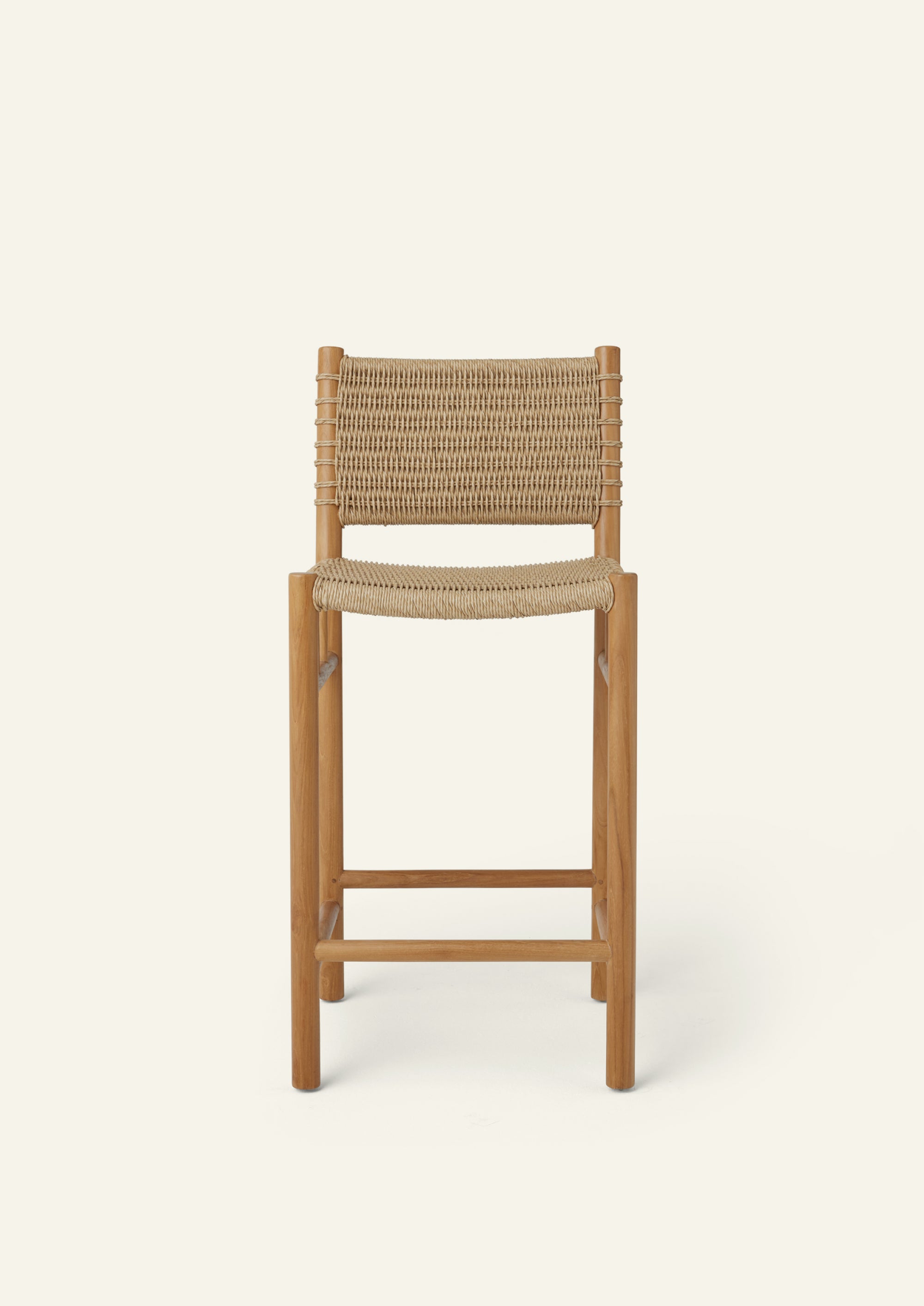 Front view of the woven counter stool showcasing its clean-lined teak frame, supportive woven backrest, and handwoven seat. Natural textures and simple proportions create a relaxed, timeless look.